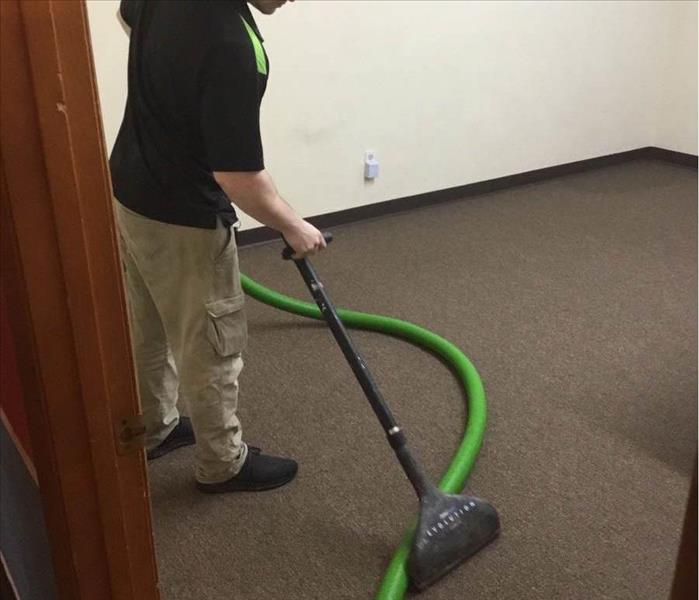 Team member extracting water with powerful vacuum.