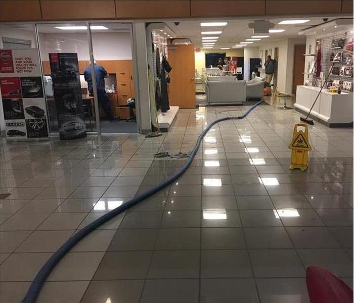 Rental car office damaged by water, hose on the floor